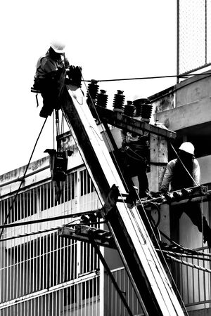 silhouette electrician working on electricity postのeditorial素材