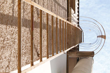 Metal staircase seen from below on a sunny dayの写真素材