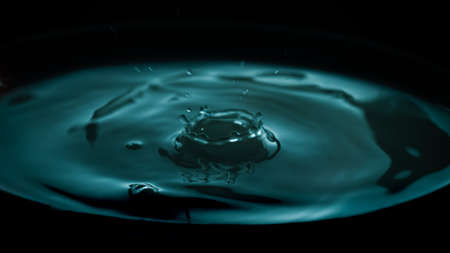 Drop of water frozen in the air with colored water