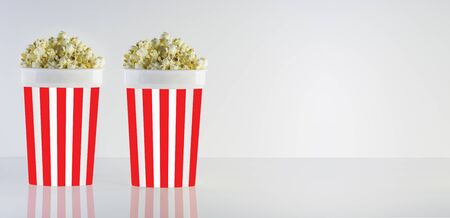 Popcorn box isolated on clean natural background. Good for watching cinema and movies. Delicious but unhealty nutrition.の写真素材