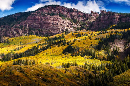 Red rock mountains and aspens during fall foliage periodの写真素材