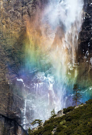 Upper Yosemite Falls becomes colorful by a bright rainbow on a nice sunny dayの写真素材