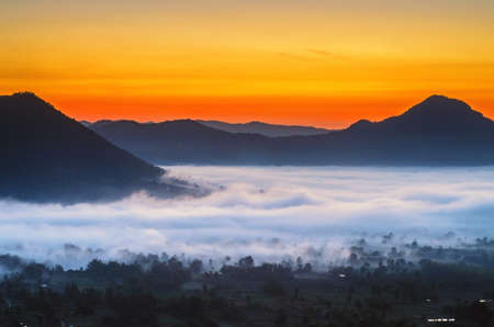 Phu Tok in the morning at sunrise is covered by sea of fog の写真素材