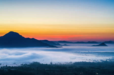Phu Tok in the morning at sunrise is covered by sea of fog の写真素材