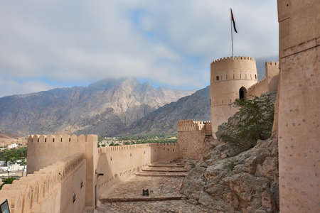Watch tower of an ancient fort in oman against the backdrop of a blue skyの写真素材