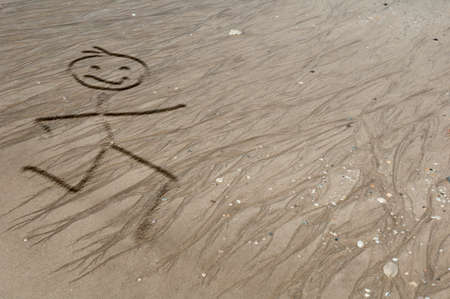 Stickman running on the sandの写真素材