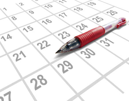 Red pen on a calendarの写真素材