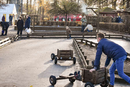 Father and son playing with cart outside during winter time. Egeskov slot, Denmarkのeditorial素材