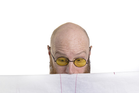 bald man looking surprised at his work isolated on white backgroundの写真素材