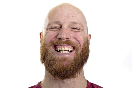 happy young man smiling at the camera isolated on white backgroundの写真素材