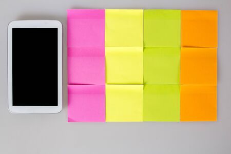 post it notes colorful blank next to mobile phoneの写真素材
