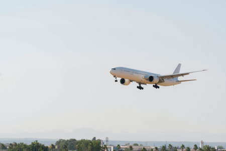 Plane landing to Airport with city and sea view