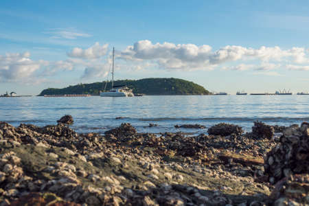 beautiful scene of boat in the sea and mountain background, Sichang island, Pattaya, Chonburi, Thailandの写真素材