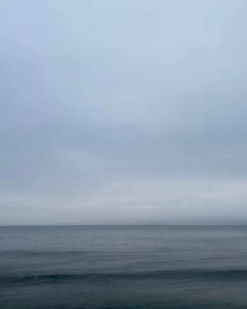 Dreamy blue view of the horizon with blue sky and dark blue ocean waterの写真素材