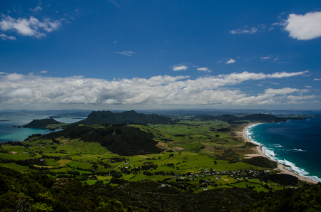 Coastline view from the top of Te Whara Track with blue sky above in Whangarei Heads, Northland, New Zealand.の写真素材