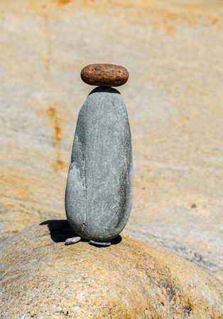 Figurine made of small stones on the beachの写真素材