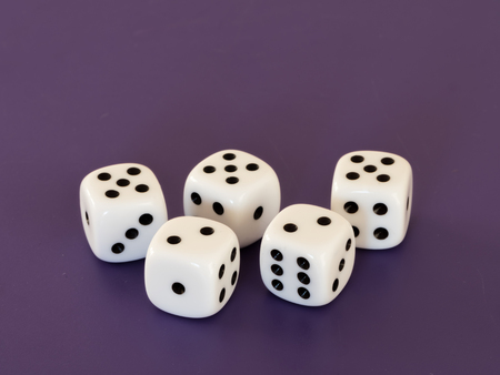 Closeup of five white dices lying on a tableの写真素材