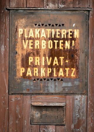 Old rusty sign for private parking space telling that placard is prohibitedの写真素材