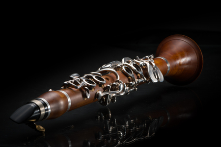 Details of a light brown G-Clarinet ("Picksuesses Hoelzl") on black backgroundの写真素材