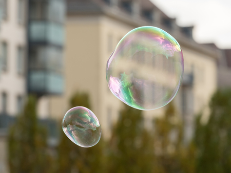 Soap bubbles in front of an old house and trees in Dresden Germany in autumn