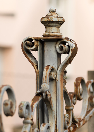 Details of an old rusty iron gate on a cloudy dayの写真素材