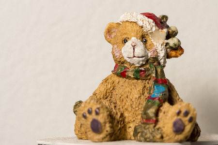 A small ceramic teddy bear figure at christmas timeの写真素材