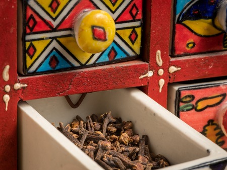 Small colorful painted box with drawers for spices, open drawerの写真素材