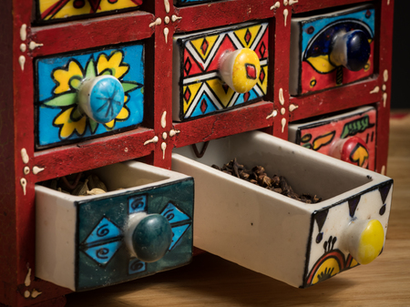 Small colorful painted box with drawers for spices, open drawersの写真素材