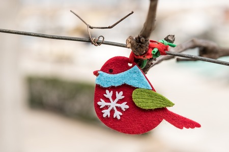 Small red handicraft bird made of felt hanging on a wire in Valun, Cres Croatiaの写真素材