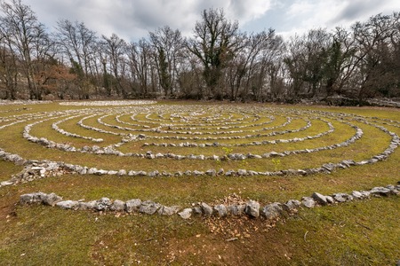 Labyrinth made of white stones on a green meadow near Beli, Cres Croatia, on a sunny day in spring