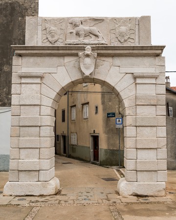 Old city gate place of Cres (Croatia) on a cloudy day in springの写真素材