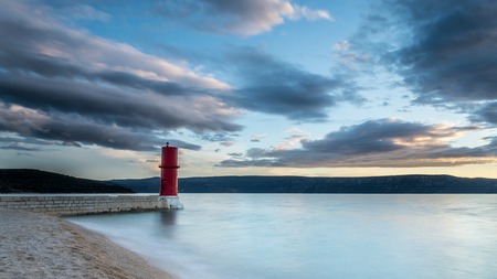 Red lighthouse of Cres (Croatia) on a cloudy day in springの写真素材