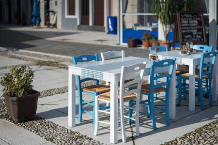 White blue table and chairs of a mediterranean restaurant (Cres, Croatia)の写真素材