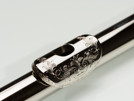 Closeup of an engraved mouth plate of a platinum plated silver fluteの写真素材