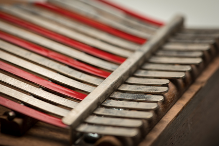 Details of a thumb piano (Kalimba, Mbira) with silver and red tines