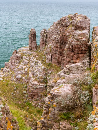 Spectacular cliffs in Cap Frehel on a cloudy day in summer (Brittany, France)