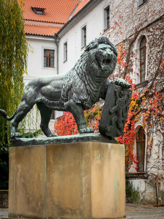 Bronze sculpture of lion on the yard of Strahov Monastery (Prague, Czech Republic)の写真素材