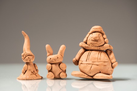 Small figurines made of clay by a childの写真素材
