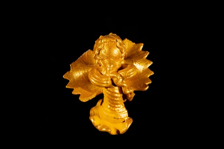 Small figure of an angel made of pasta, used for decorating a christmas tree isolated on black backgroundの写真素材