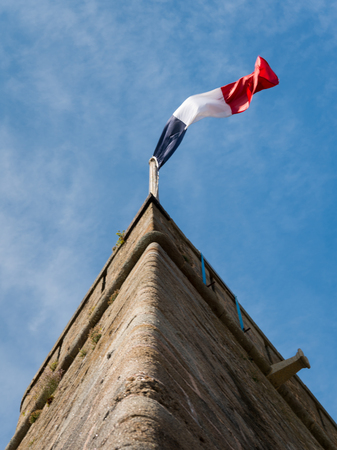 French flag on the wall of an old fort in Saint-Malo (Brittany, France)の写真素材