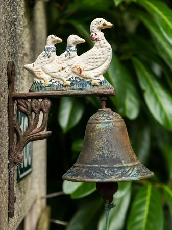 Old vintage rusty doorbell with three ducks, made of ironの写真素材