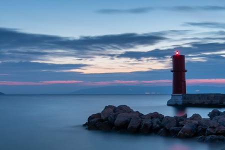 Red lighthouse of Cres (Croatia) on a sunny evening in spring, sunset