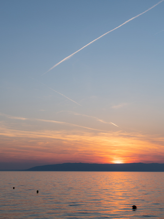 Sunset over the sea in Croatia (island Cres), blue skyの写真素材