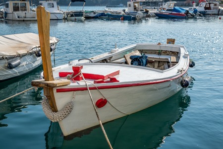 A beautiful white, red fishing boat on a sunny day in Croatiaの写真素材