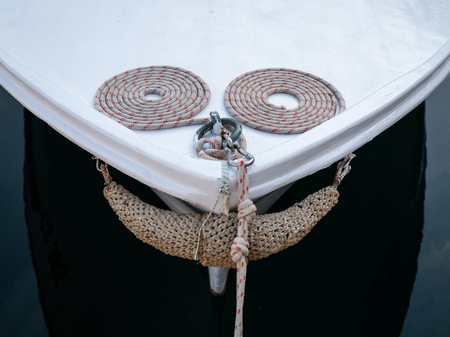 Bow of a small white fishing boat with ropes in Croatia