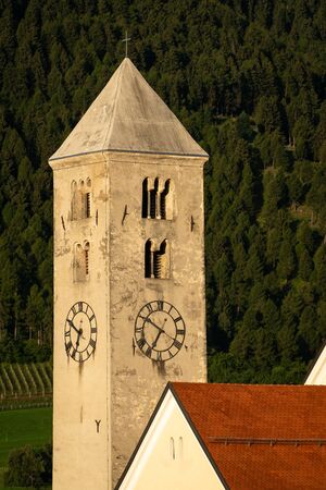 Church tower of St. Johannes in Laas (South Tyrol, Italy) on a sunny morning in summer