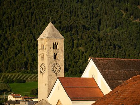 Church tower of St. Johannes in Laas (South Tyrol, Italy) on a sunny morning in summerの写真素材