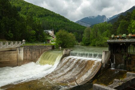 Weir on the river Schwarza in Hirschwang (Austria) on a cloudy day in summerの写真素材