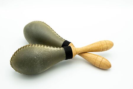 Closeup of a pair of rawhide maracas lying on a white undergroundの写真素材