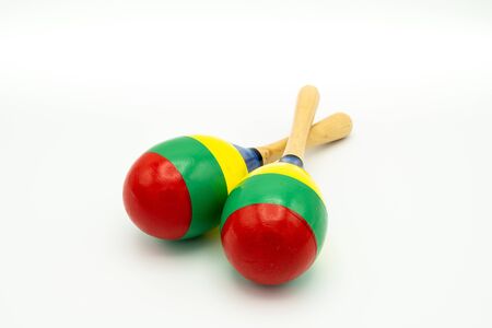 Closeup of a pair of colorful maracas lying on a white undergroundの写真素材